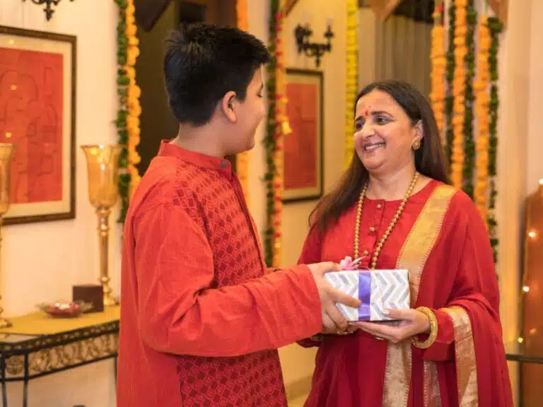 Best gift ideas for old parents in India: son giving present to mother