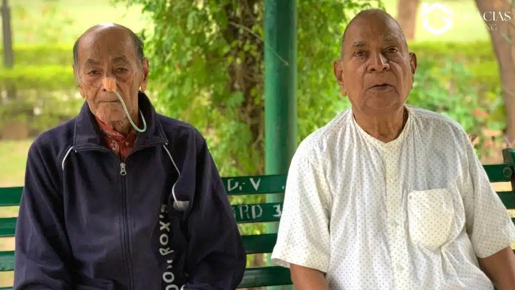 Elderly residents sitting together in a peaceful private care home garden in India