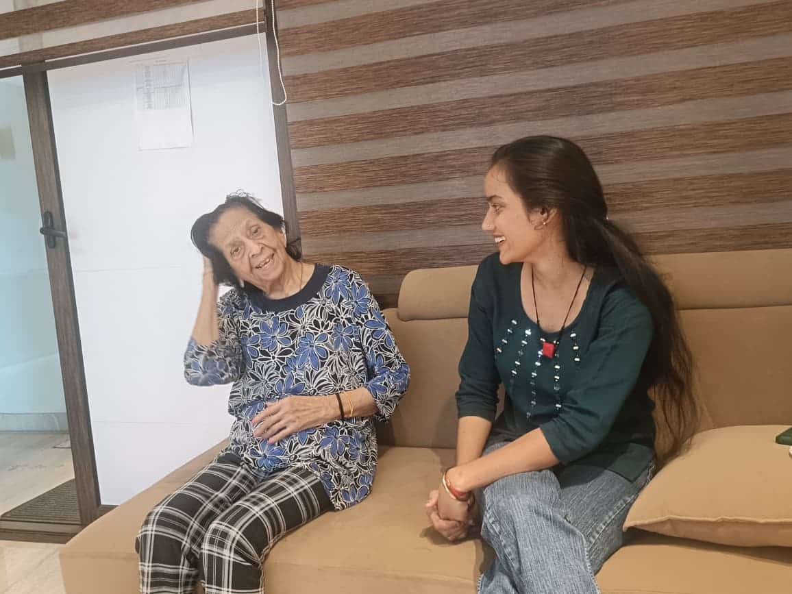 Senior care in Gurgaon at Gracias Living, with a caregiver sharing time with an older resident