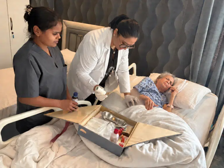 Nurse and caregiver providing bed sore treatment to an elderly resident at Gracias Living