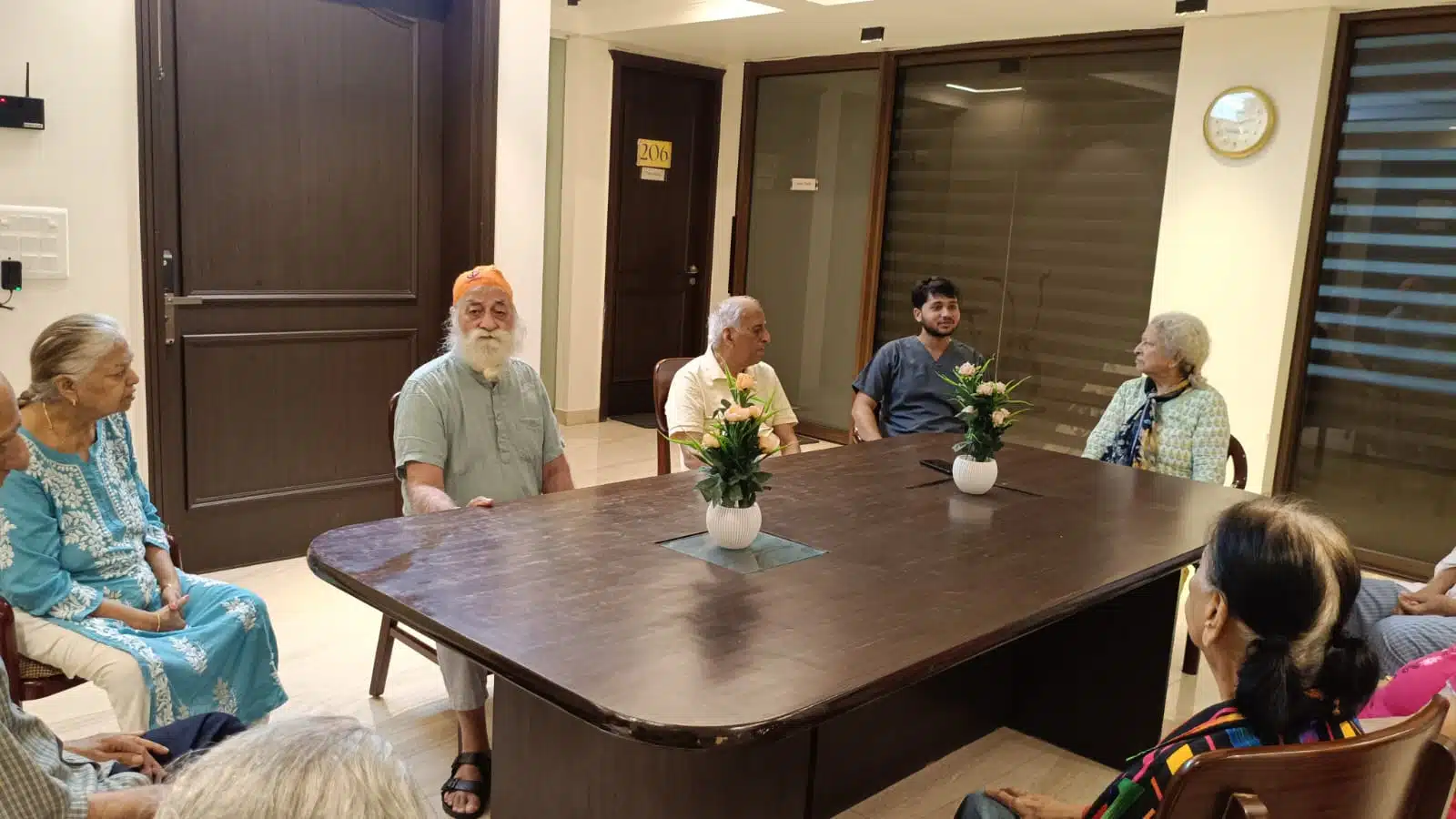 Seniors at Gracias Living gathered together indoors for an evening chat, staying warm and connected during winter