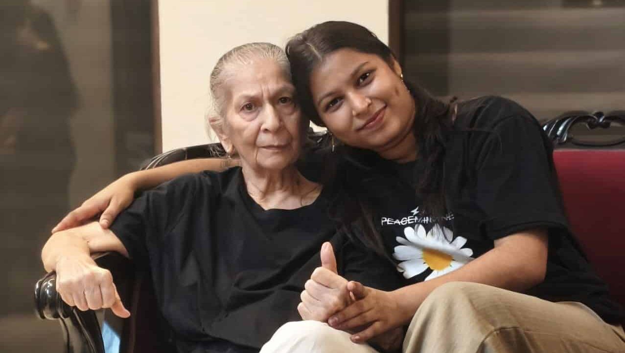 A caregiver at Gracias Living attending closely to a resident, the kind of daily hands-on support winter joint and heart care needs