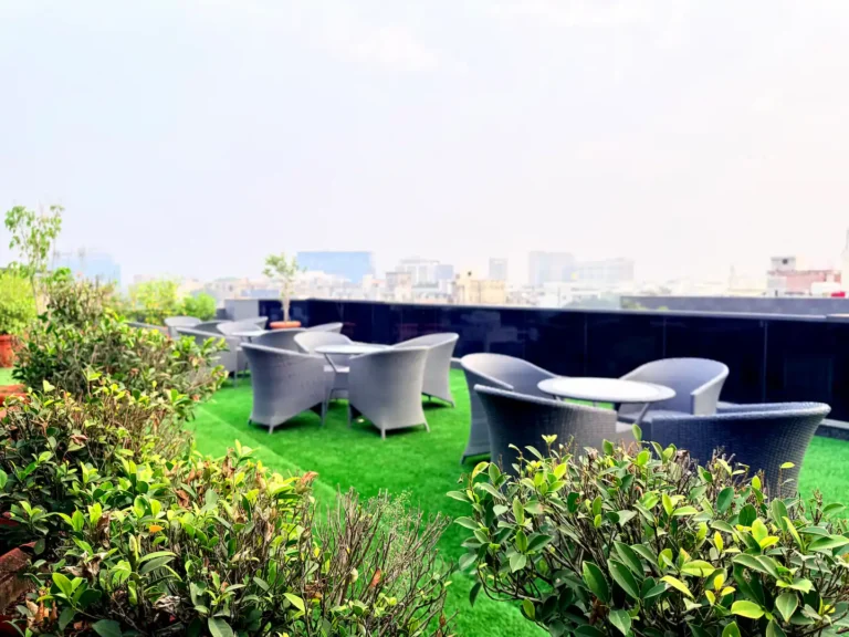 Rooftop terrace at Gracias Living with hazy Delhi NCR skyline in the background during pollution season