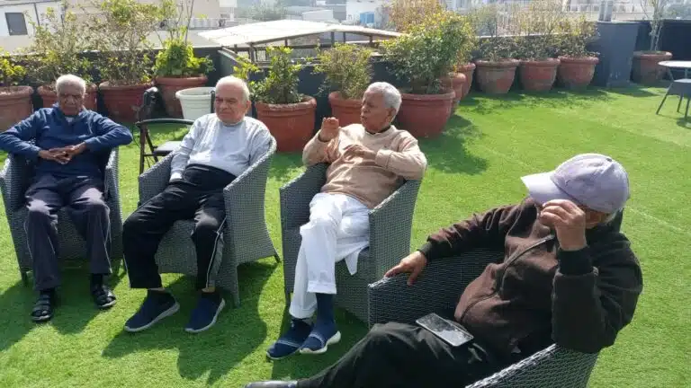 Seniors enjoying the winter sun in the terrace garden at Gracias Living, Gurgaon